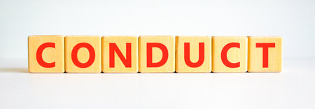 Conduct symbol. Concept word Conduct on beautiful wooden blocks. Beautiful white background. Business conduct concept. Copy space.の写真素材