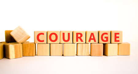 Courage symbol. Concept word Courage on beautiful wooden blocks. Beautiful white background. Business courage concept. Copy space.の写真素材