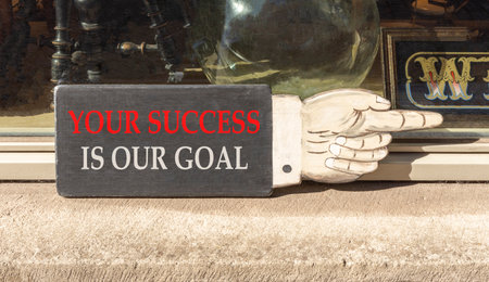 Your success is our goal symbol. Concept words Your success is our goal on beautiful wooden black...