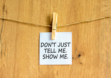 Tell or show symbol. Concept words Do not just tell me, show me on beautiful white paper on wooden...