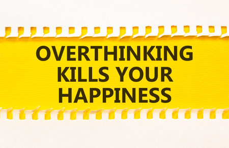 Overthinking kills your happiness symbol. Concept words Overthinking kills your happiness on yellow paper. Beautiful white paper background. Business overthinking kills happiness concept. Copy space.の写真素材