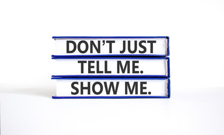 Tell or show symbol. Concept words Do not just tell me, show me on beautiful books. Beautiful white...