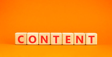 Content symbol. Concept word Content on beautiful wooden blocks. Beautiful orange background. Business content concept. Copy space.の写真素材
