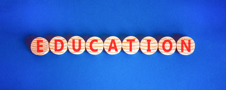Education symbol. Concept word Education on beautiful wooden circles. Beautiful blue background. Business education concept. Copy space.の写真素材
