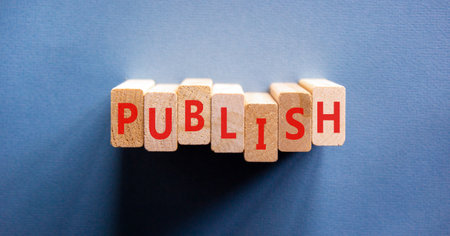 Publish word symbol. Concept word Publish on beautiful wooden blocks. Beautiful blue background. Business publish word concept. Copy space.の写真素材