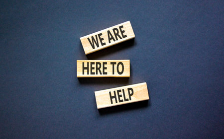 Support, help and we are here to help symbol. Concept words We are here to help on beautiful wooden...