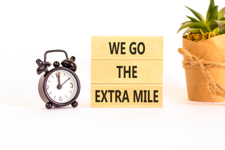 Support, help we go the extra mile symbol. Concept words We go the extra mile on beautiful wooden...