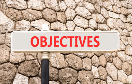 Objectives symbol. Concept word Objectives on beautiful gray road sign. Beautiful stone wall background. Business objectives concept. Copy space.の写真素材