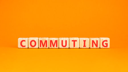 Commuting symbol. Concept word Commuting on beautiful wooden blocks. Beautiful orange background. Business education commuting concept. Copy space.の写真素材