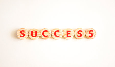 Successful success symbol. Concept word Success on beautiful wooden circles. Beautiful white background. Business success or successful concept. Copy space.の写真素材