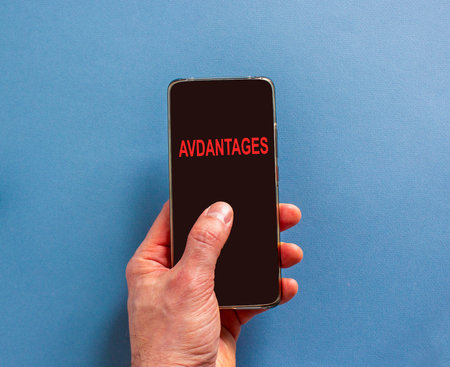 Advantages symbol. Concept word Advantages on beautiful cell phone's screen in businessman's hand....