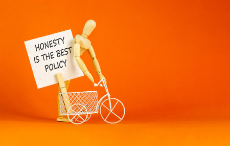 Honesty is the best policy. Concept words Honesty is the best policy on beautiful white paper. Beautiful orange background. Business honesty is the best policy concept. Copy space.の写真素材
