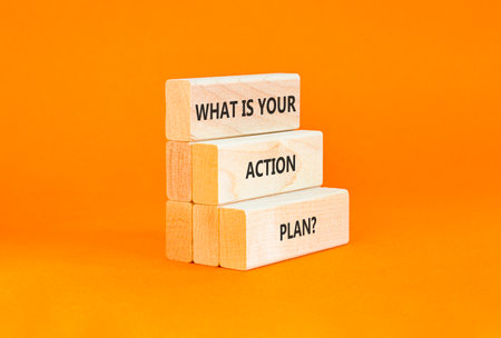 What is your action plan symbol. Concept words What is your action plan on beautiful wooden blocks. Beautiful orange background. Business what is your action plan concept. Copy space.の写真素材