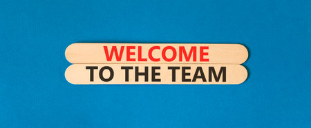 Support, help welcome to the team symbol. Concept words Welcome to the team on beautiful wooden sticks. Beautiful blue background. Business welcome to the team concept. Copy space.の写真素材