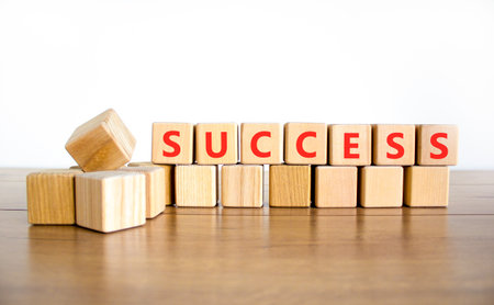 Successful success symbol. Concept word Success on beautiful wooden blocks. Beautiful wooden table white background. Business success or successful concept. Copy space.の写真素材