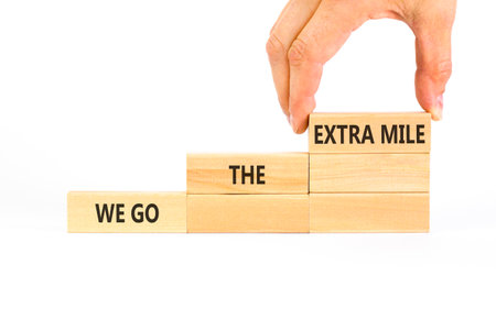 Support, help we go the extra mile symbol. Concept words We go the extra mile on beautiful wooden...