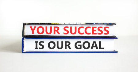 Support, help your success is our goal symbol. Concept words Your success is our goal on beautiful books. Beautiful white paper background. Business your success is our goal concept. Copy space.の写真素材