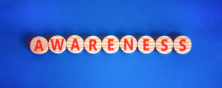 Awareness symbol. Concept word awareness on beautiful wooden circles. Beautiful blue background. Business education awareness concept. Copy space.の写真素材
