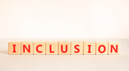 Inclusion symbol. Concept words Inclusion on beautiful wooden blocks. Beautiful white and gray background. Business support inclusion concept. Copy space.の写真素材