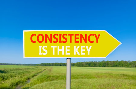 Consistency is the key symbol. Concept words Consistency is the key on beautiful yellow road sign....