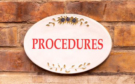 Procedures symbol. Concept word Procedures on beautiful white marble sign plate. Beautiful ancient brick wall background. Business procedures concept. Copy space.の写真素材