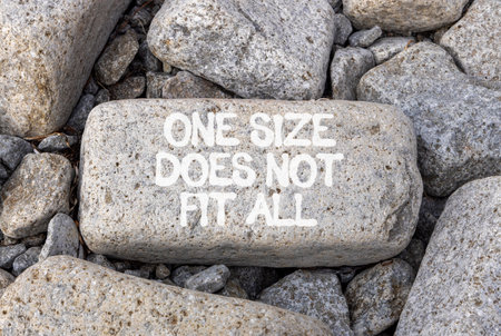 One size does not fit all symbol. Concept words One size does not fit all on beautiful gray stone. Beautiful gray stones background. Business one size does not fit all concept. Copy space.の写真素材