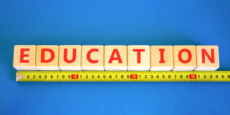 Education symbol. Concept word Education on beautiful wooden blocks. Beautiful blue background....