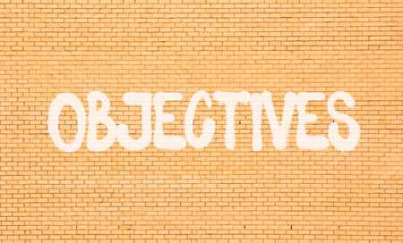 Objectives symbol. Concept word Objectives on beautiful big brown brick wall. Beautiful big brown...