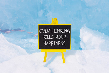 Overthinking kills your happiness symbol. Concept words Overthinking kills your happiness on beautiful blackboard. Beautiful ice background. Business overthinking kills happiness concept. Copy spaceの写真素材