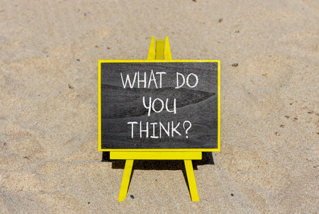 Support, help what do you think symbol. Concept words What do you think on beautiful blackboard. Beautiful sand beach background. Business what do you think concept. Copy space.の写真素材