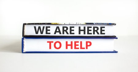 Support, help and we are here to help symbol. Concept words We are here to help on beautiful books. Beautiful white paper background. Business we are here to help concept. Copy space.の写真素材