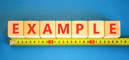 Example examples symbol. Concept word Example on beautiful wooden blocks. Beautiful blue background. Beautiful yellow ruler. Business example examples concept. Copy space.の写真素材