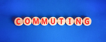 Commuting symbol. Concept word Commuting on beautiful wooden circles. Beautiful blue background. Business education commuting concept. Copy space.の写真素材