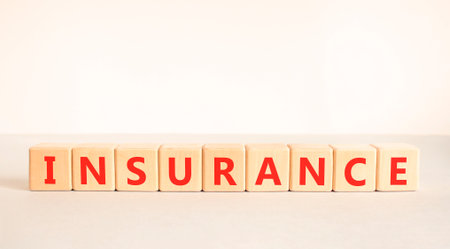 Insurance symbol. Concept words Insurance on beautiful wooden blocks. Beautiful white and gray background. Business support medical insurance concept. Copy space.の写真素材