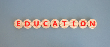 Education symbol. Concept word Education on beautiful wooden circles. Beautiful gray background. Business education concept. Copy space.の写真素材
