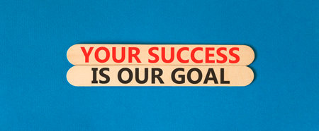 Your success is our goal symbol. Concept words Your success is our goal on beautiful wooden sticks. Beautiful blue background. Business your success is our goal concept. Copy space.の写真素材