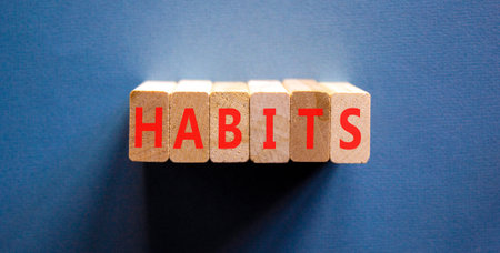 Habits support and help symbol. Concept word Habits on beautiful wooden blocks. Beautiful blue background. Business psychological habits support and help concept. Copy space.の写真素材