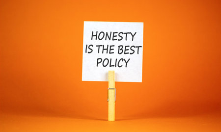 Concept words Honesty is the best policy on beautiful white paper on clothespins. Beautiful orange...