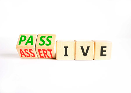 Passive or assertive symbol. Concept words Passive or Assertive on beautiful wooden cubes. Beautiful...