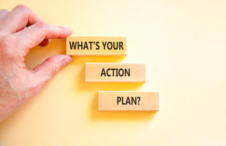 What is your action plan symbol. Concept words What is your action plan on beautiful blocks. Beautiful white background. Businessman's hand. Copy space.の写真素材