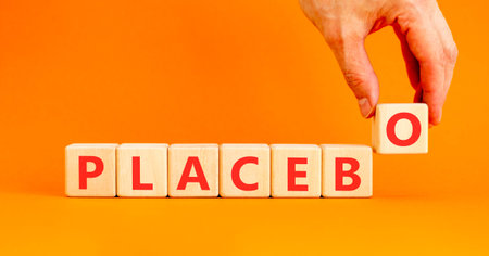 Placebo word medical symbol. Concept word Placebo on beautiful wooden blocks. Beautiful orange background. Doctor's hand. Business placebo word medical concept. Copy space.の写真素材