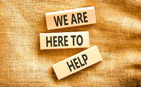 Support, help and we are here to help symbol. Concept words We are here to help on beautiful wooden blocks. Beautiful canvas background. Business we are here to help concept. Copy space.の写真素材
