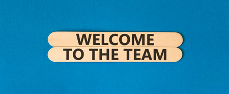 Support, help welcome to the team symbol. Concept words Welcome to the team on beautiful wooden sticks. Beautiful blue background. Business welcome to the team concept. Copy space.の写真素材