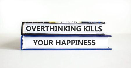 Overthinking kills your happiness symbol. Concept words Overthinking kills your happiness on books. Beautiful white paper background. Business overthinking kills happiness concept. Copy space.の写真素材