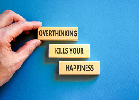 Overthinking kills your happiness symbol. Concept words Overthinking kills your happiness on wooden blocks. Beautiful blue background. Business overthinking kills happiness concept. Copy space.の写真素材