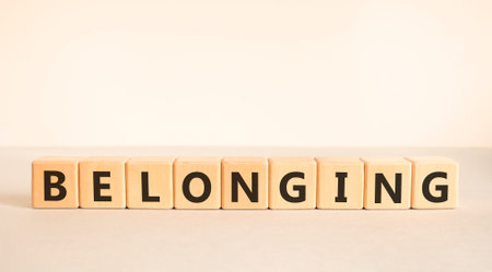 Belonging symbol. Concept words Belonging on beautiful wooden blocks. Beautiful white and gray background. Business support belonging concept. Copy space.の写真素材