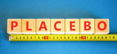 Placebo word medical symbol. Concept word Placebo on beautiful wooden blocks. Beautiful blue...