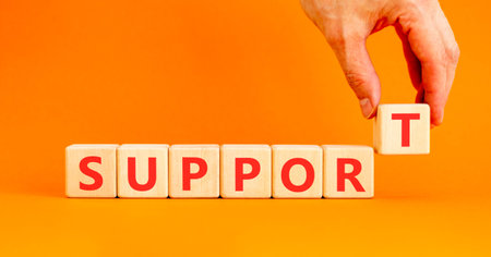 Support help word symbol. Concept word Support on beautiful wooden blocks. Beautiful orange...
