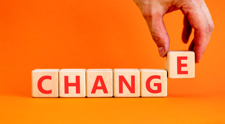 Change symbol. Concept word Change on beautiful wooden blocks. Beautiful orange background....
