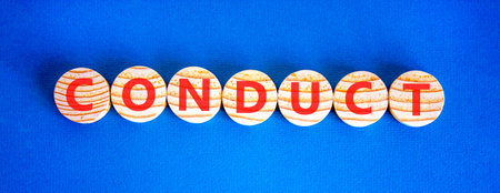 Conduct symbol. Concept word Conduct on beautiful wooden circles. Beautiful blue background....